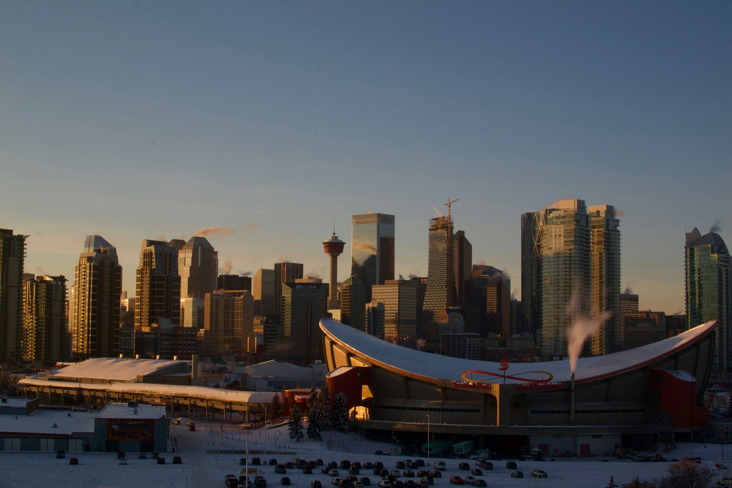 Calgary skyline at golden hour, with the Scotiabank Saddledome and Calgary Tower